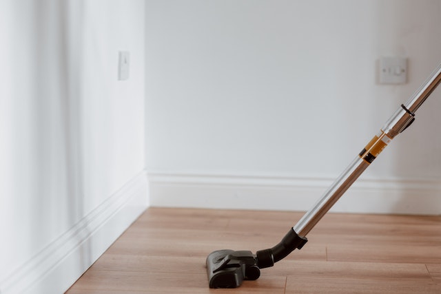 vacuum cleaner being used on light wood floors